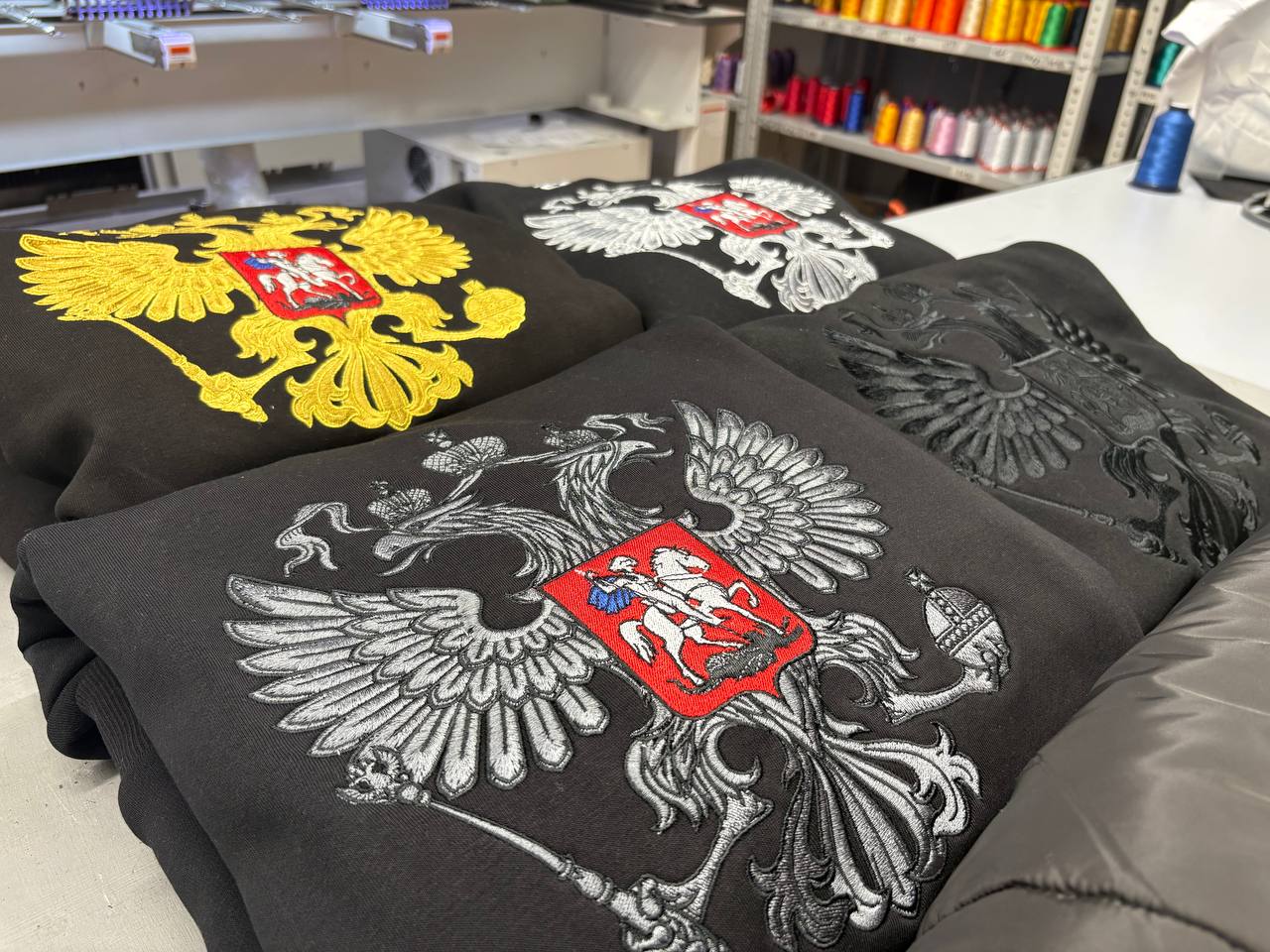 Мерч из худи и жилетов с вышивкой герба РФ для селлера Wildberries